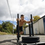 athletic-man-exercising-with-sled-outside-gym-royalty-free-image-1056425154-1551576538